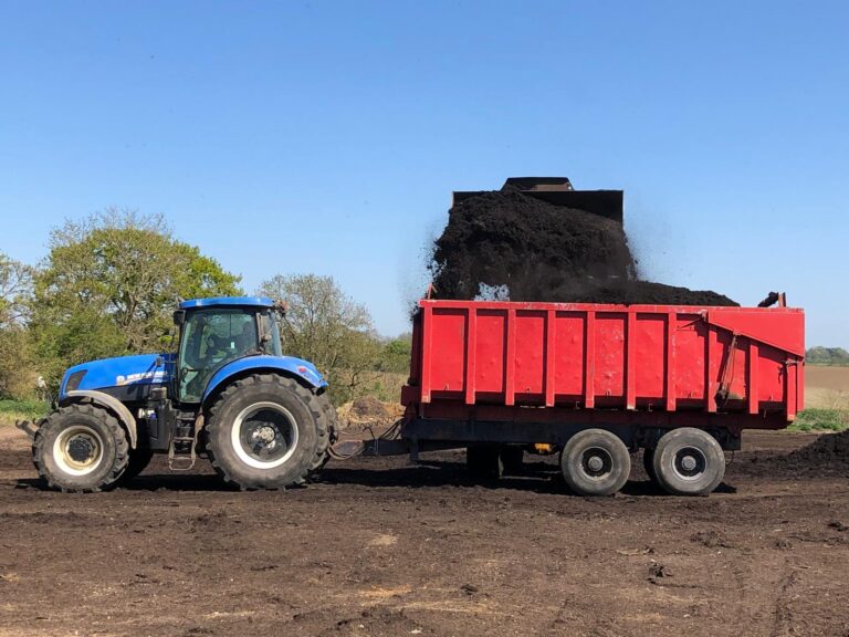 Compost shovelled into tractor trailer